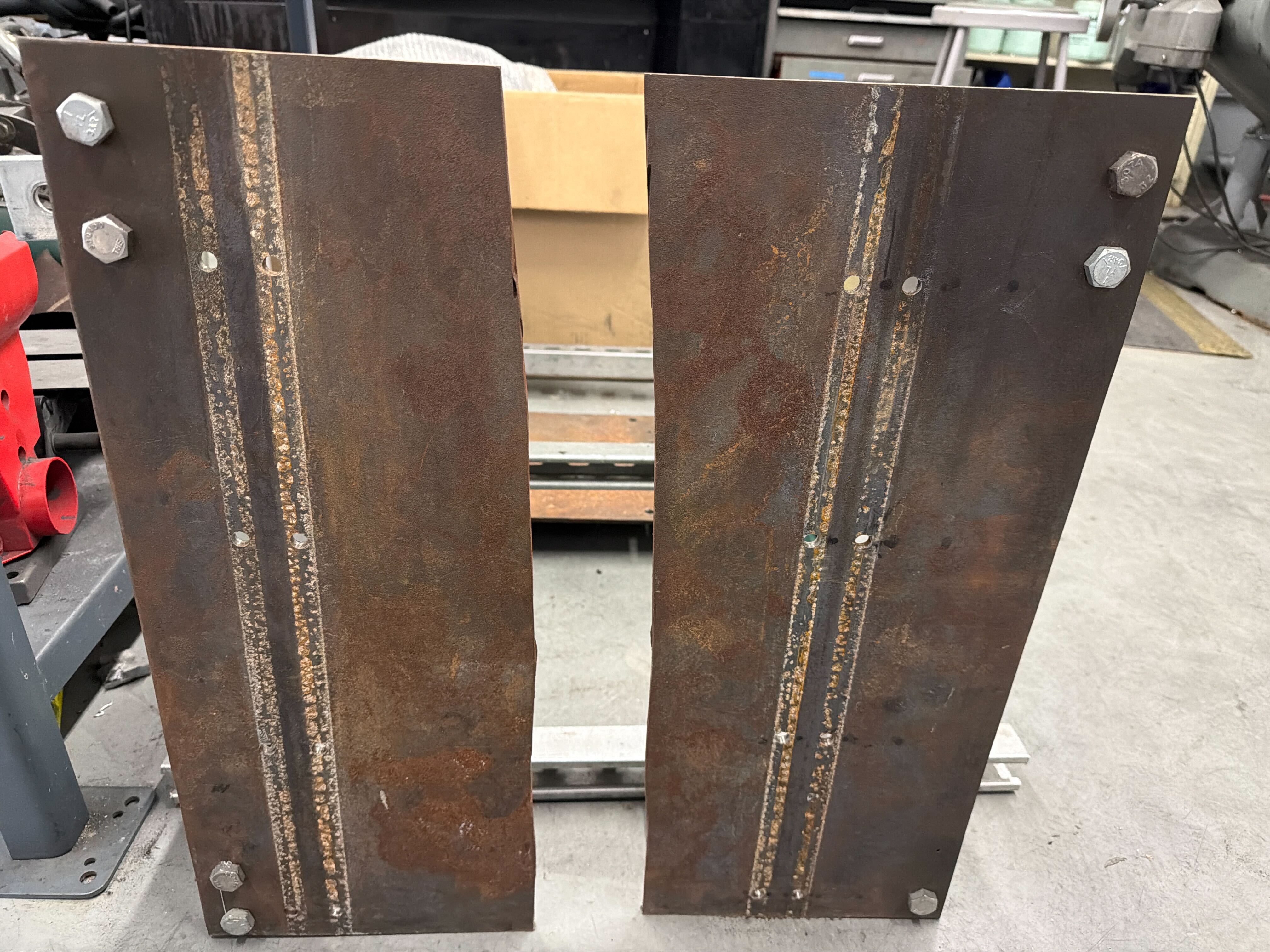 Broken aluminum base plate from the previous test stand