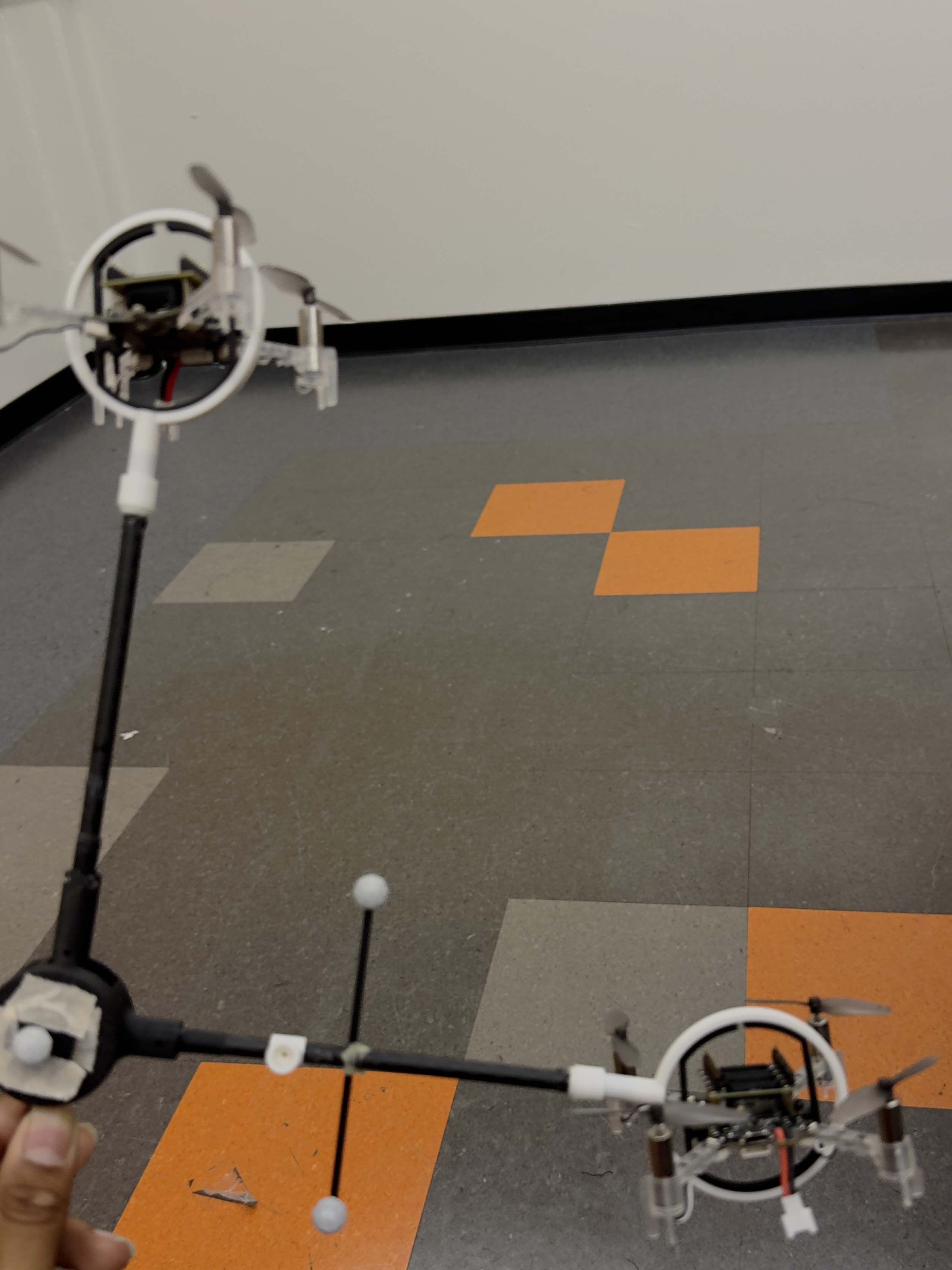 Carbon-fiber frame with gimbal-mounted Crazyflie 2.1 quadcopters and motion-capture markers