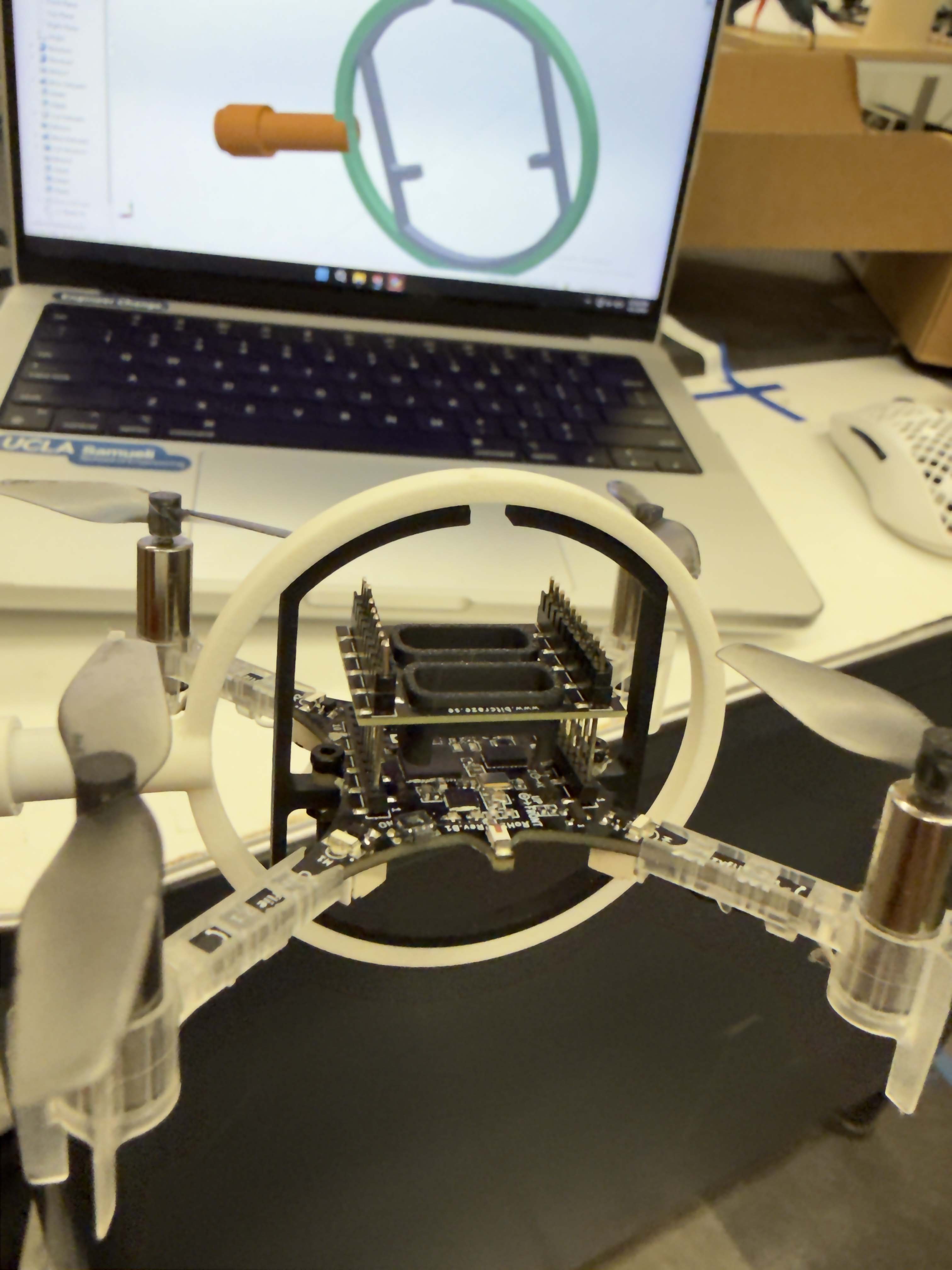 3D-printed PLA gimbal ring around a Crazyflie 2.1, with a joint iteration in SolidWorks behind
